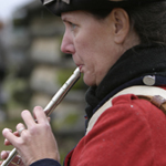 Reenactor playing the tin whistle