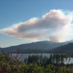 smoke column visible over lake