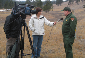 Wind Cave's Park Biologist gives an interview to a television reporter.