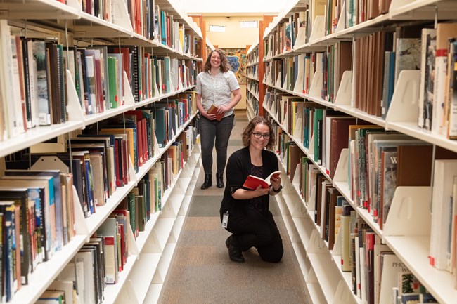 Research librarians in book stacks