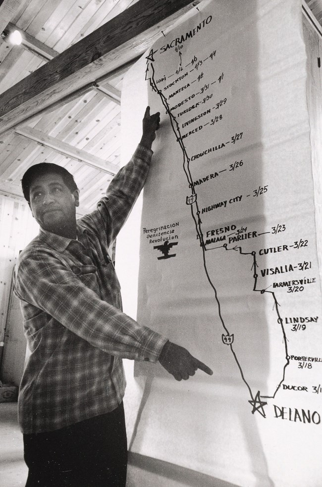 Chavez_1966_Map_Yale Image of César E. Chávez standing in front of a map with route of 1966 march.