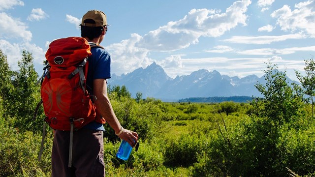 Hiker with backpack and water bottle