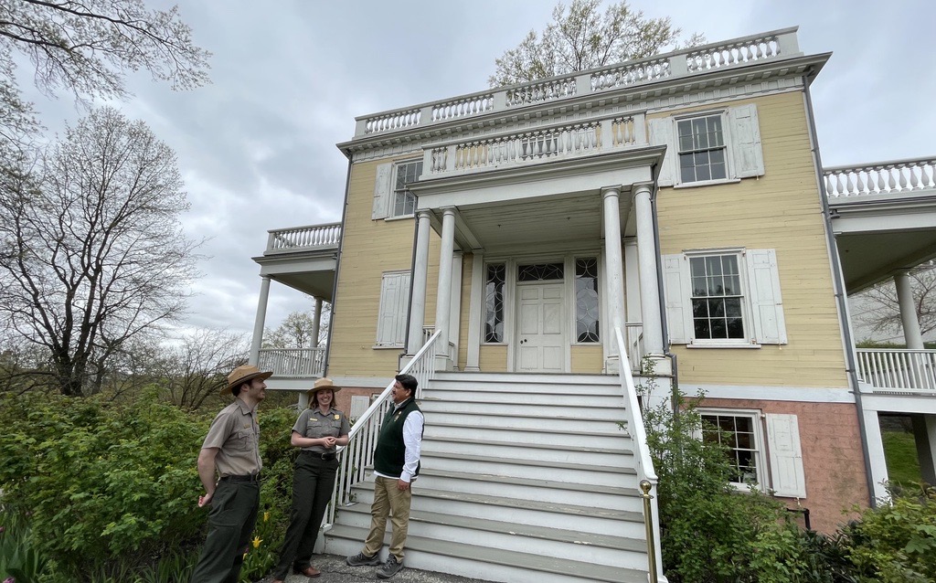 National Park Service Director Chuck Sams visits with uniformed national park rangers at Hamilton Grange National Memorial in Harlem.