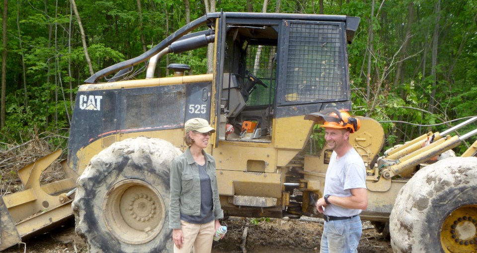 Experienced Services Program participant Man and woman talking in front of backhoe