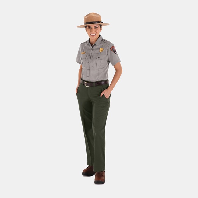 Summer Service Uniform An NPS employee wearing a straw ranger hat, gray short sleeve shirt, green pants, and brown shoes