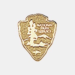 Tie Tack A golden tie tack in the shape of the NPS Arrowhead