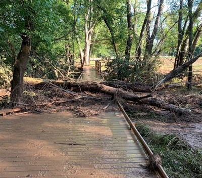 Gambrill Mill boardwalk at Monocacy National Battlefield a wooden boardwalk along a treeline is covered with mud and a downed tree and tree limbs