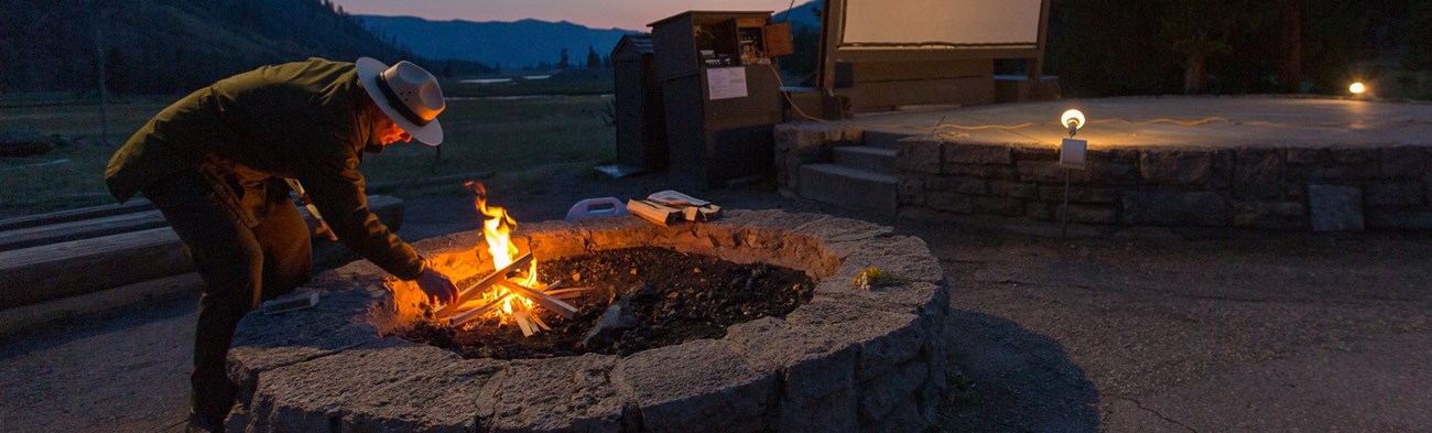 Ranger lighting a campfire