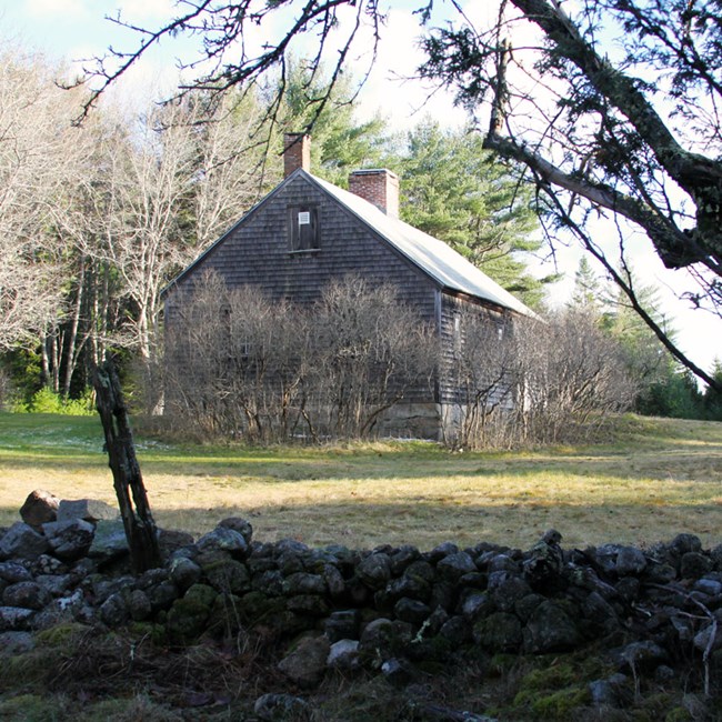 An old rock wall and the farm house at the Carroll Homestead - December 8, 2011