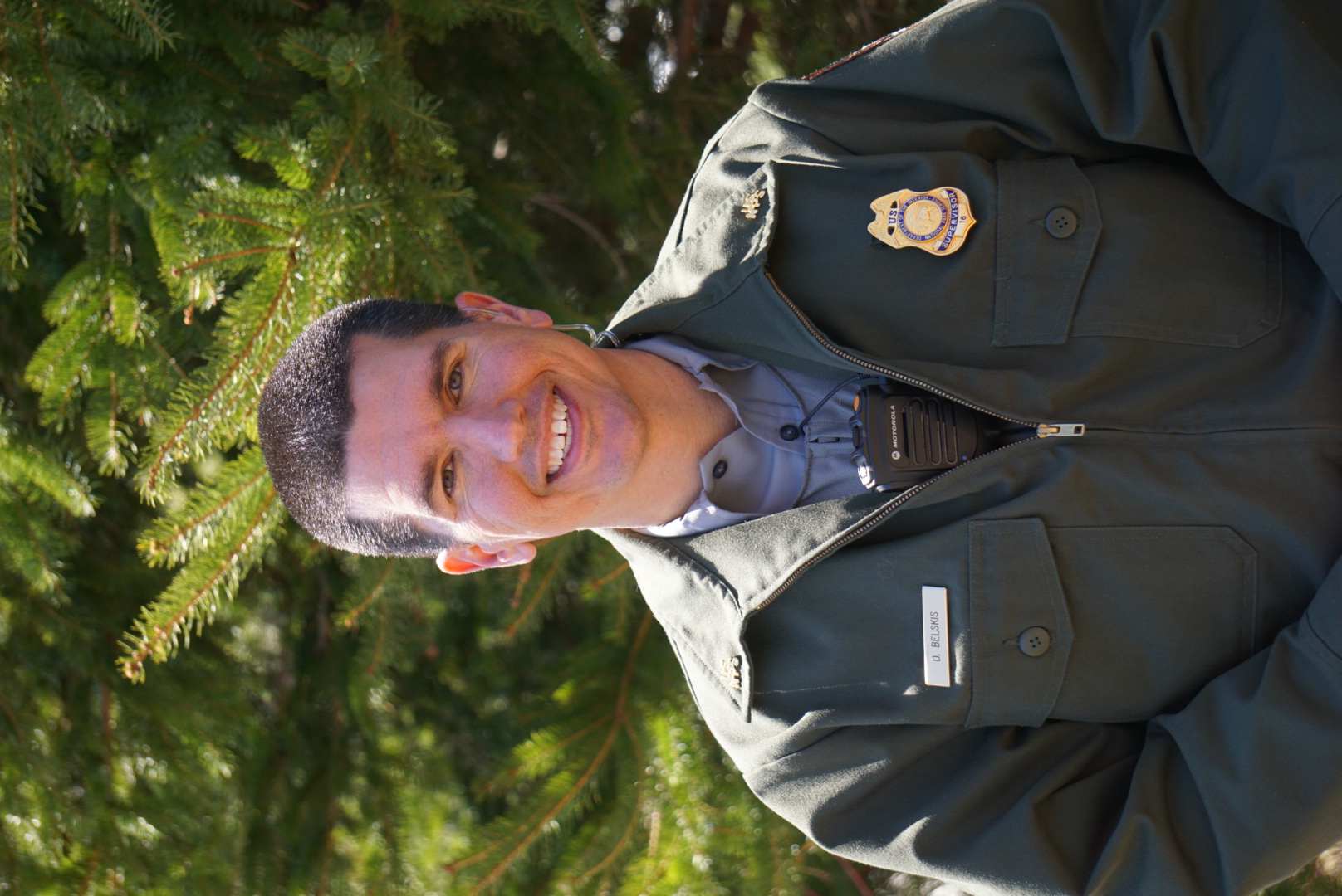 Darren Belskis, dressed in Park Service Uniform, smiles at the camera.