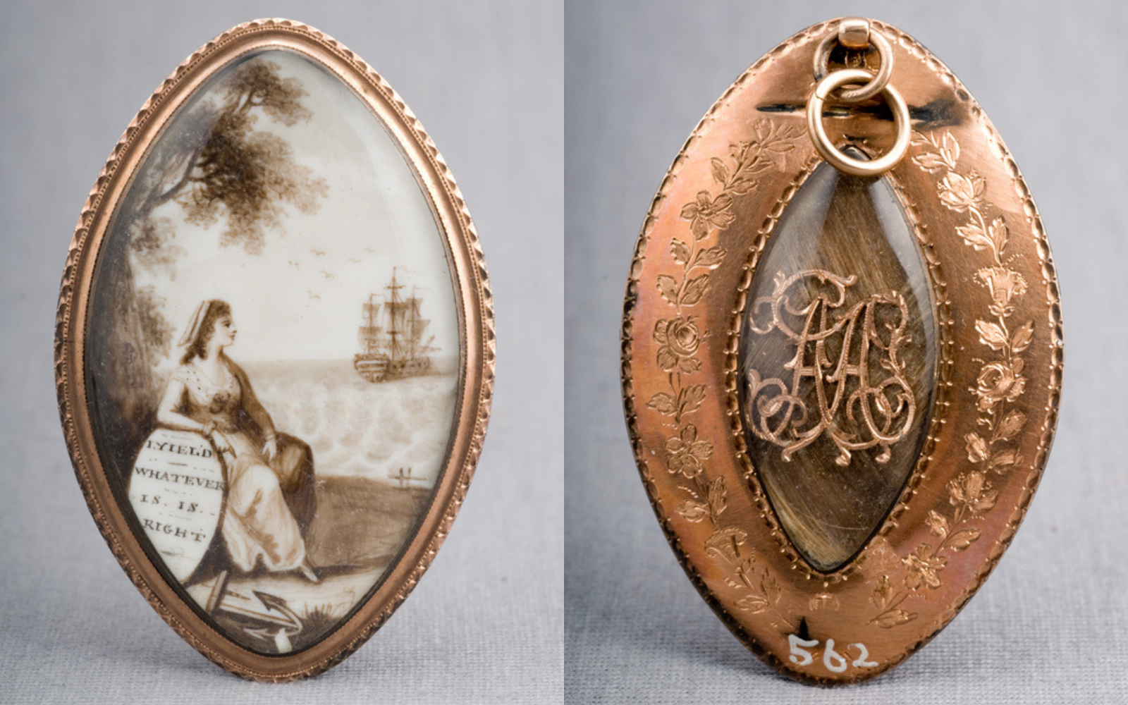 Front and Back of Abigail's Locket An oval shaped locket. Front side depicts a woman sitting on a beach looking out toward a ship at sea. Back side contains braided human hair and the initials AA under a glass dome.