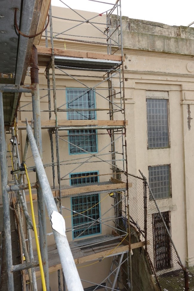 Exterior view of Alcatraz cellhouse with scaffolding.