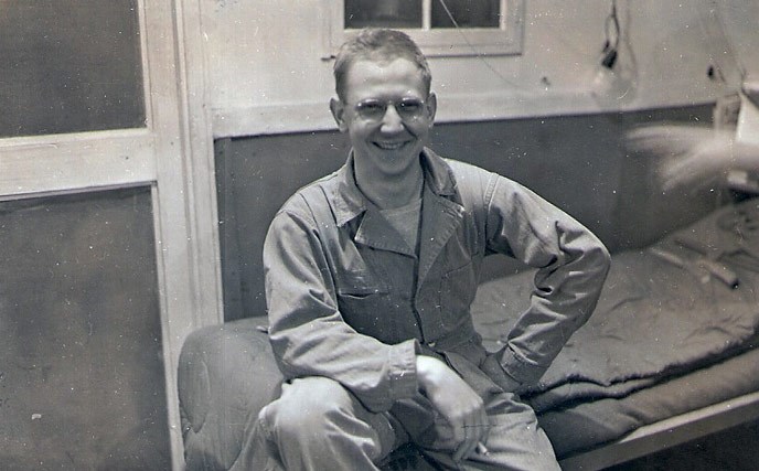historic photo of uniformed soldier, cot
