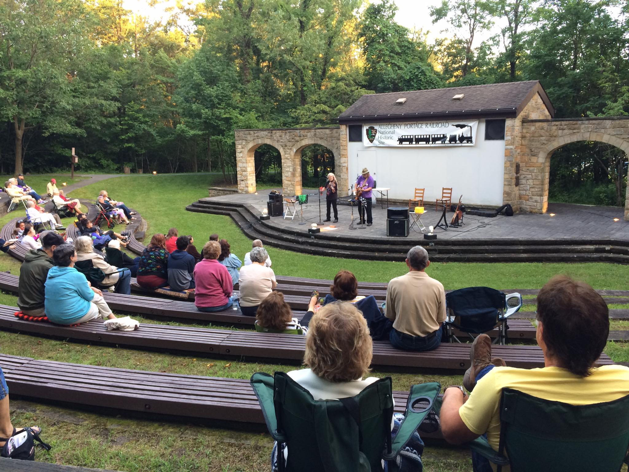 A band performs at an outdoor amphitheater.