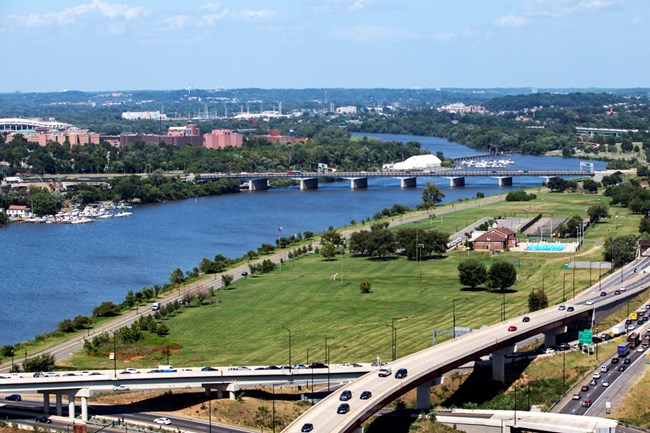 A bridge crosses a river in a busy city