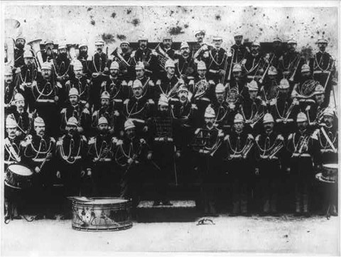 A large group of people in uniform with drums