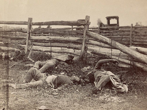 dead soldiers along a fence