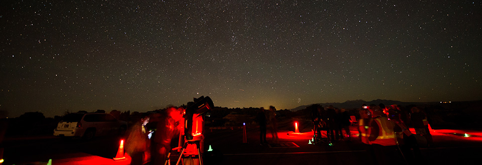 people use a telescope with stars overhead