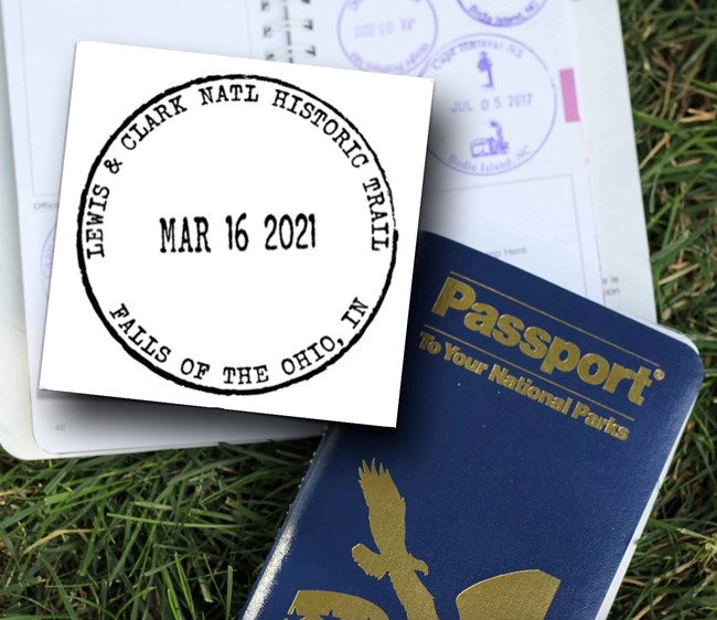 A Passport to America’s National Park book – one opened to a page with several round passport stamps