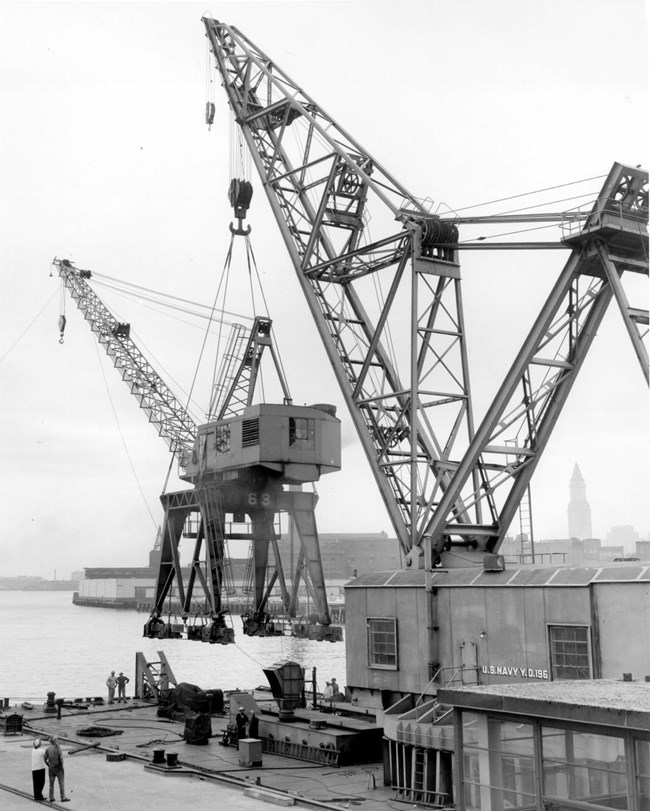 a large crane lifting a smaller crane