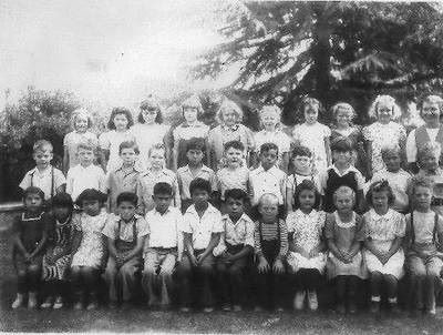 Black and white school photo of elementary students in three rows