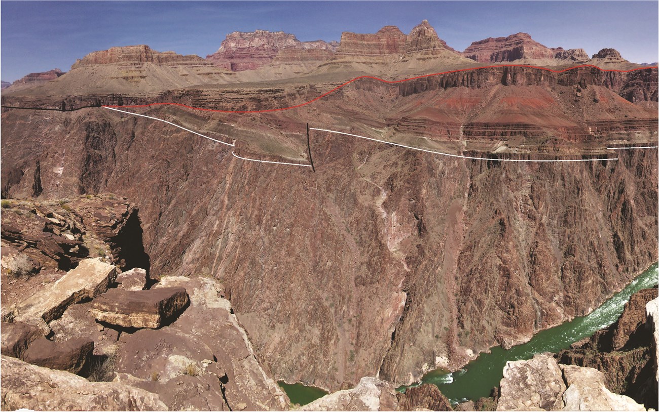 19_Figure 19 200703 JA(1) Photo of rocky cliffs and buttes with a line overlay highlighting a geologic contact.