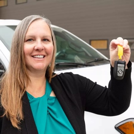Managing Fleet Operations a woman holding up car keys