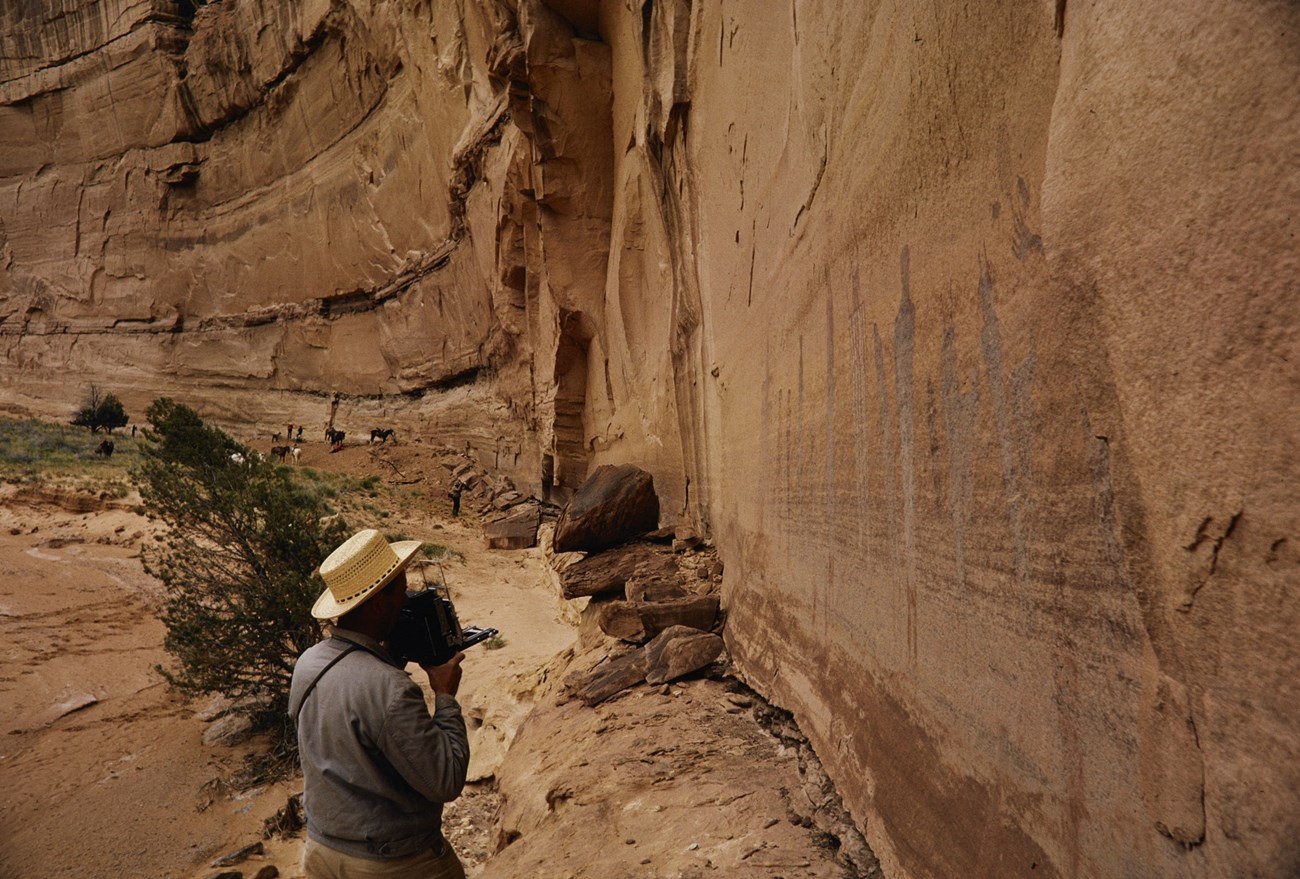 A person looks at pictographs