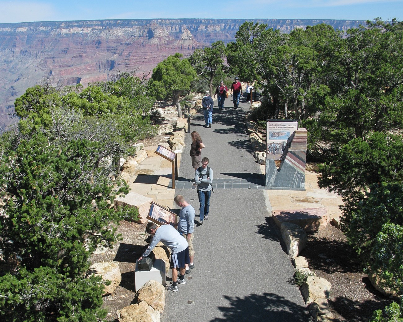 4_MQ Main portal and visitors5066006972_ffb9560cbc_o Photo of people strolling on an asphalt trail.