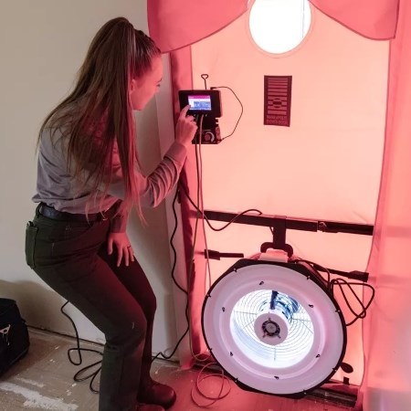 Performing Energy Audits a park ranger operating a fan in a doorway