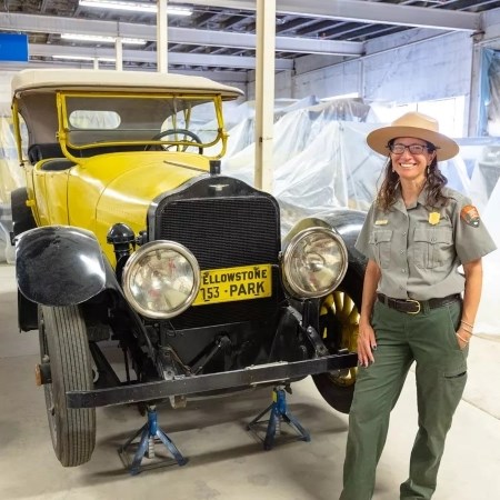Curating the Historic Vehicle Collection a park ranger standing next to a historic vehicle