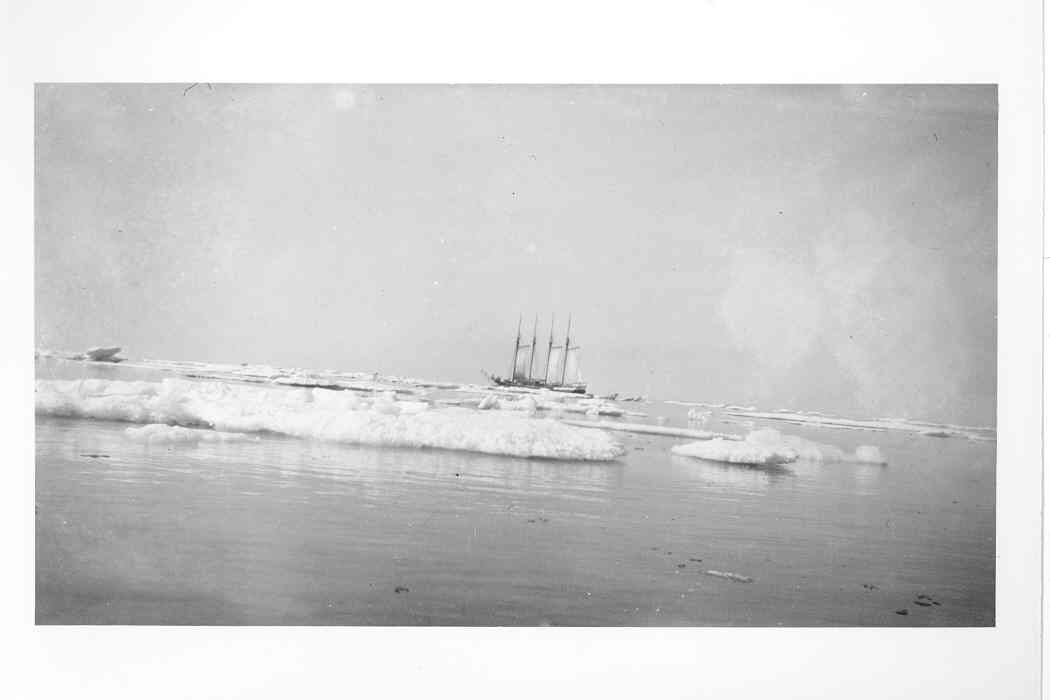 A trading ship on the Chuckchi Sea surrounded by large ice floes.