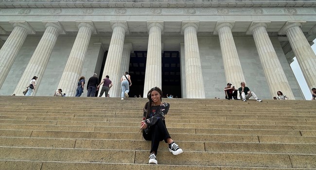 Lincoln Memorial Intern sitting on steps of a memorial