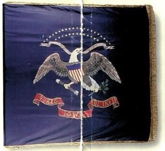 Blue flag with eagle holding shield and arrows with gold text in red banner