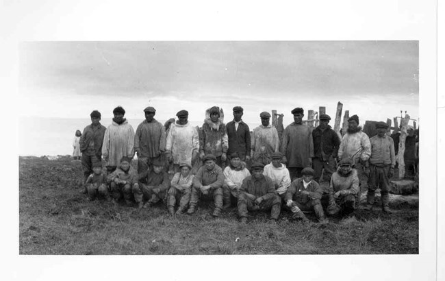 A group picture of 21 reindeer handlers at Qaggat Reindeer Corral.