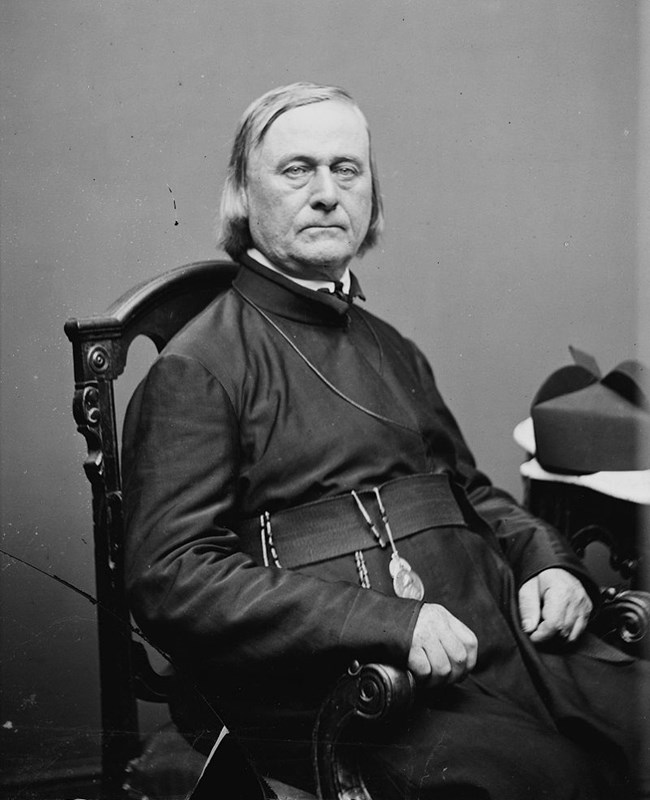Pierre-Jean De Smet A black and white image of a man in a black robe sitting in a chair.
