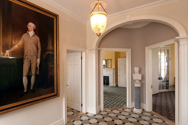 Image of entrance hall with painting and bust of Alexander Hamilton.