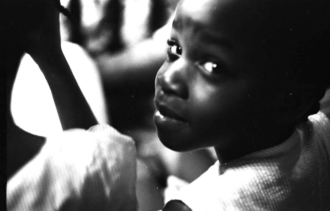 Little girl in the audience at Brown Chapel AME Church in Selma, Alabama, during a civil rights meeting.