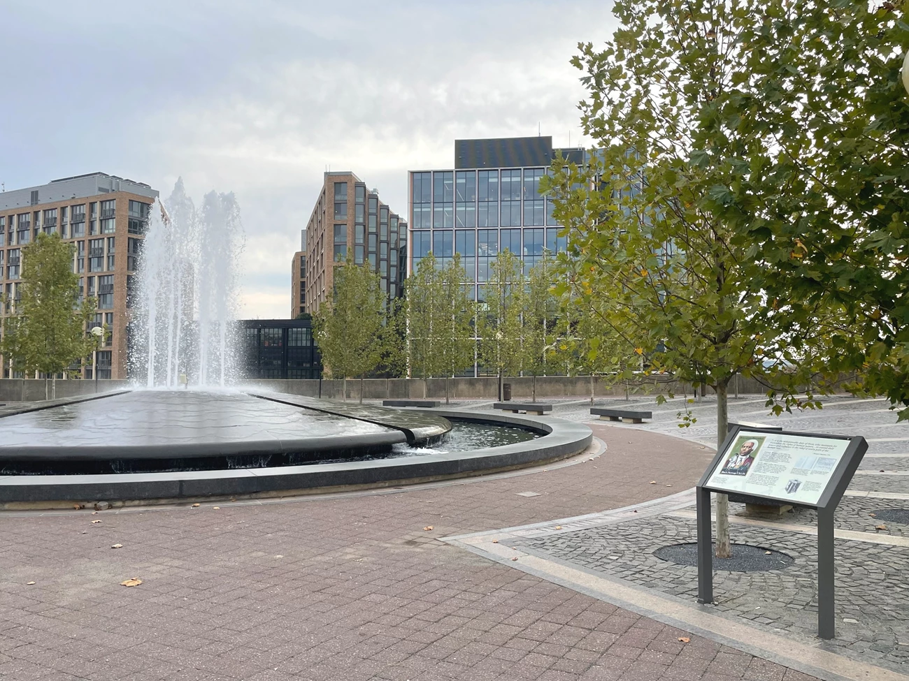 Banneker Park Nov 2022 NPS Photo Nate Adams fountain wayside crop Round fountain in the plaza of Benjamin Banneker Park with wayside information panel on right
