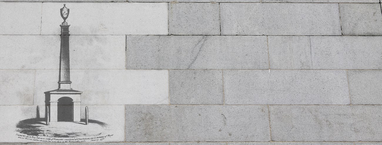 Photo of granite blocks with a historic image of a historic monument overlayed on several of the blocks.