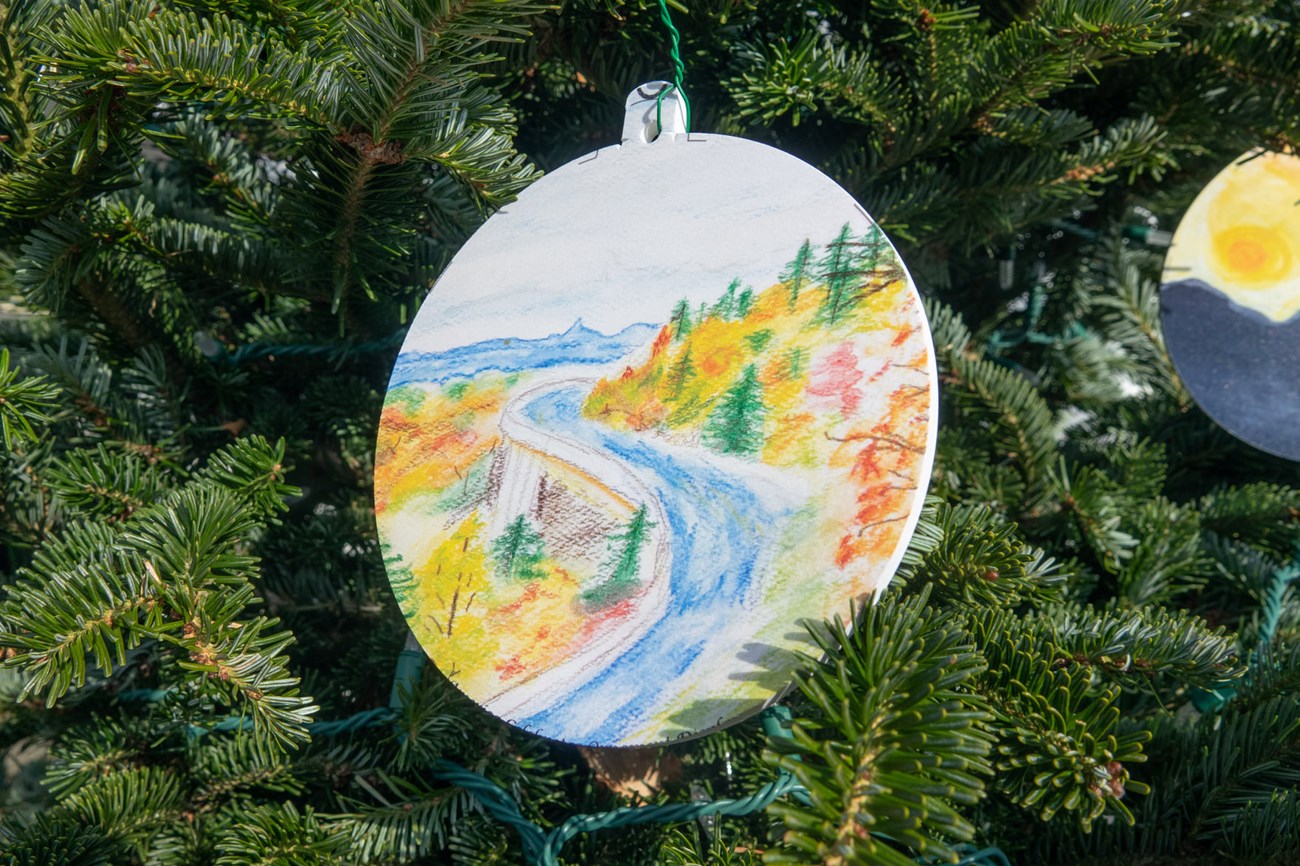 image of drawing of trees and a highway, making up blue ridge parkway, hanging from christmas tree