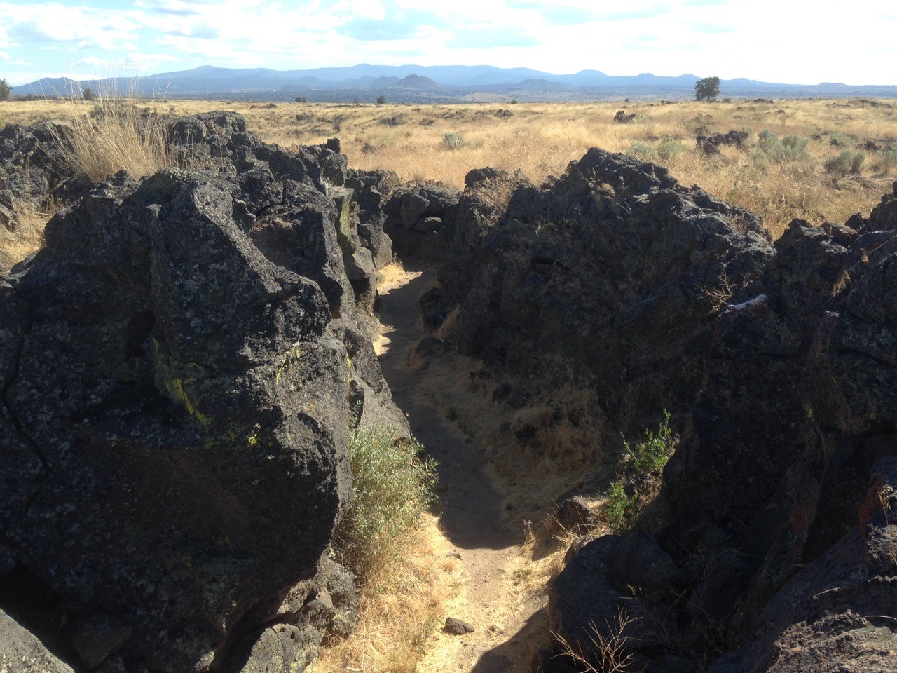 photo of lava rock outcrop and grassy mesa