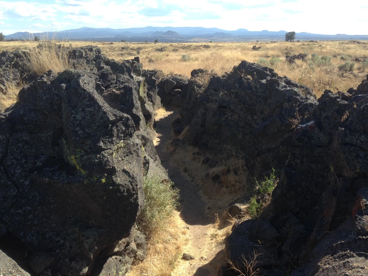 Captain Jack photo of lava rock outcrop and grassy mesa