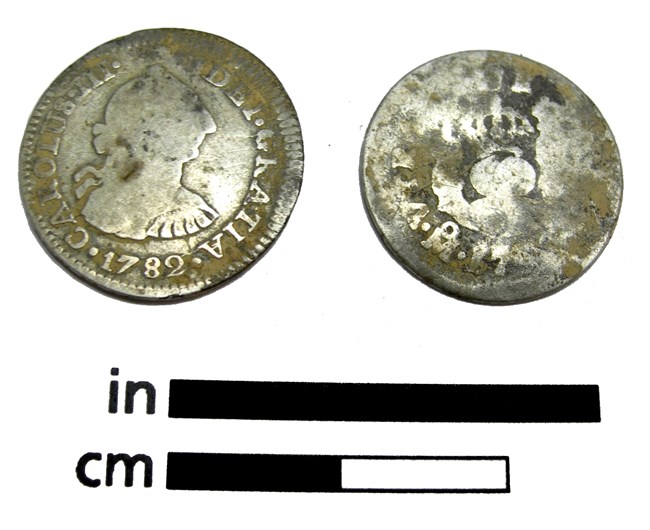 A silver coin with a 1782 mint date that archeologists can use to determine a TPQ Front and back of a silver coin that has a profile and says Carolus the III, DEI GRATIA 1782. The back side is illegible.