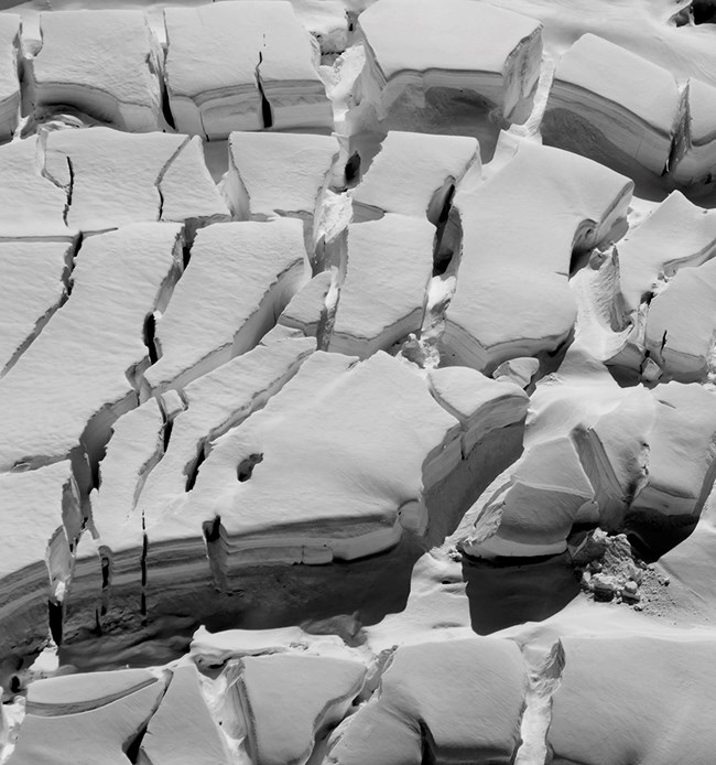 CrevassesKennicott_20170712_WRST_KenHill_cropweb Black and white image of glacier crevasses.