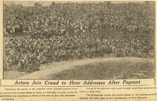 Crowd2 Faded newsprint picture of hundreds of people in a crowd, peering at a miniature fort while a performance is enacted around it.