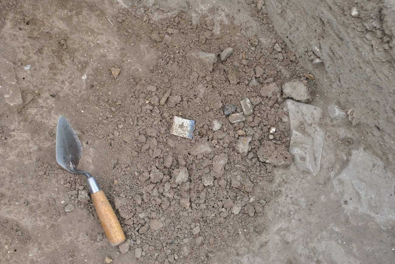 Trowel next to artifacts on the ground