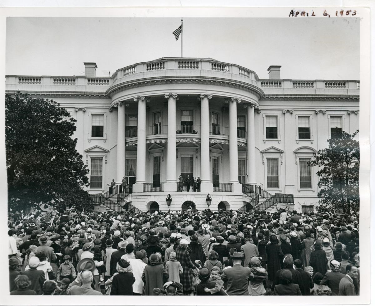 A black and white image of a large crowd on the south lawn of the White House