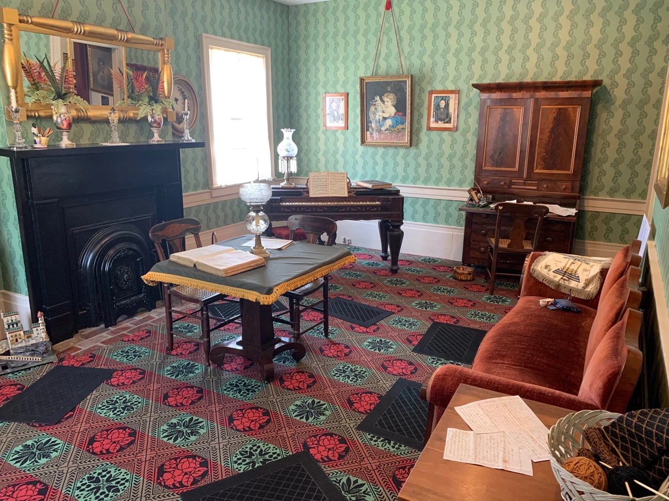 FB Post Mount Parlor 3 Takeover the Network Color photograph of a Victorian Parlor. The walls are covered with a mint green wallpaper, stamped with darker green flora and fauna. Victorian era furnishings sit throughout the room.