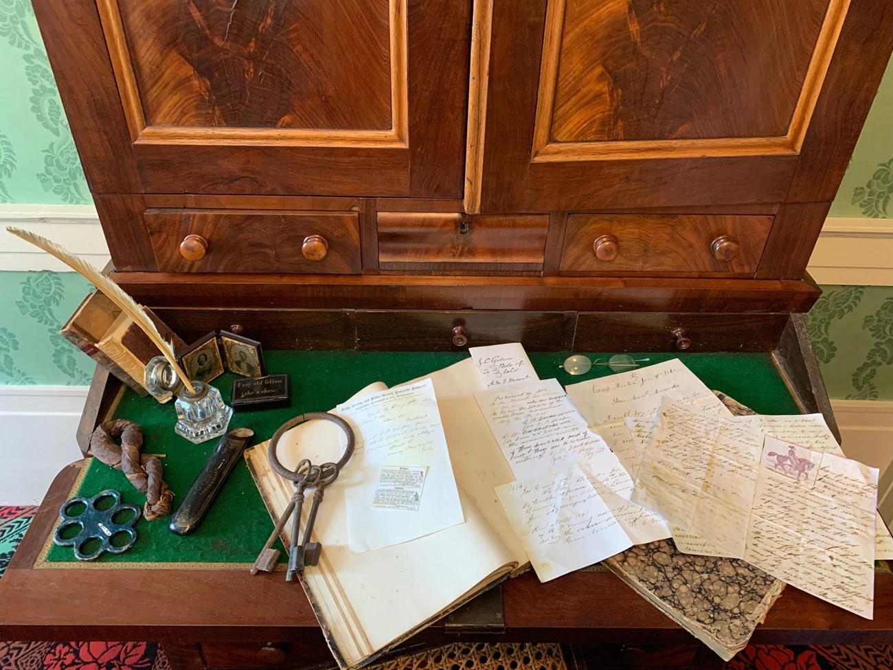 FB Post Mount Parlor 5 Takeover the Network Writing instruments and parchment sit on a 19th century desk